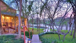 A pathway leading to a building with a staircase and a lantern. - Spacious Riverfront Home (Martindale)
