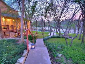 Lushly landscaped grounds leading down to the water