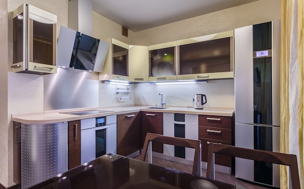 Enjoy cooking in this well-equipped kitchen with a refrigerator, oven, microwave, sink, and coffee maker.