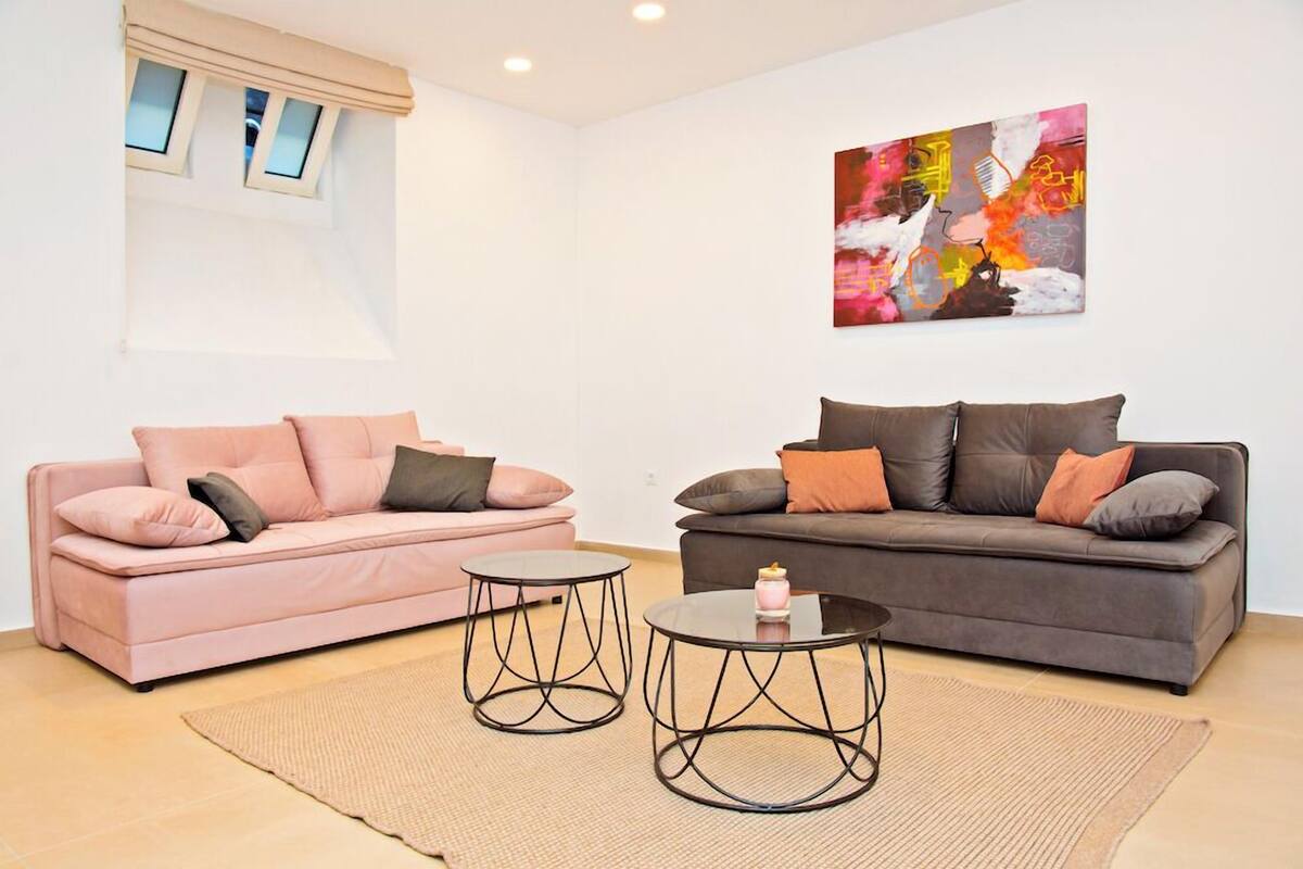 A living room with two sofas, a coffee table, and a rug.