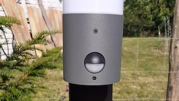 A grey and white outdoor electrical box with a plug and a label that reads "greenup system" and "25kW/230V".