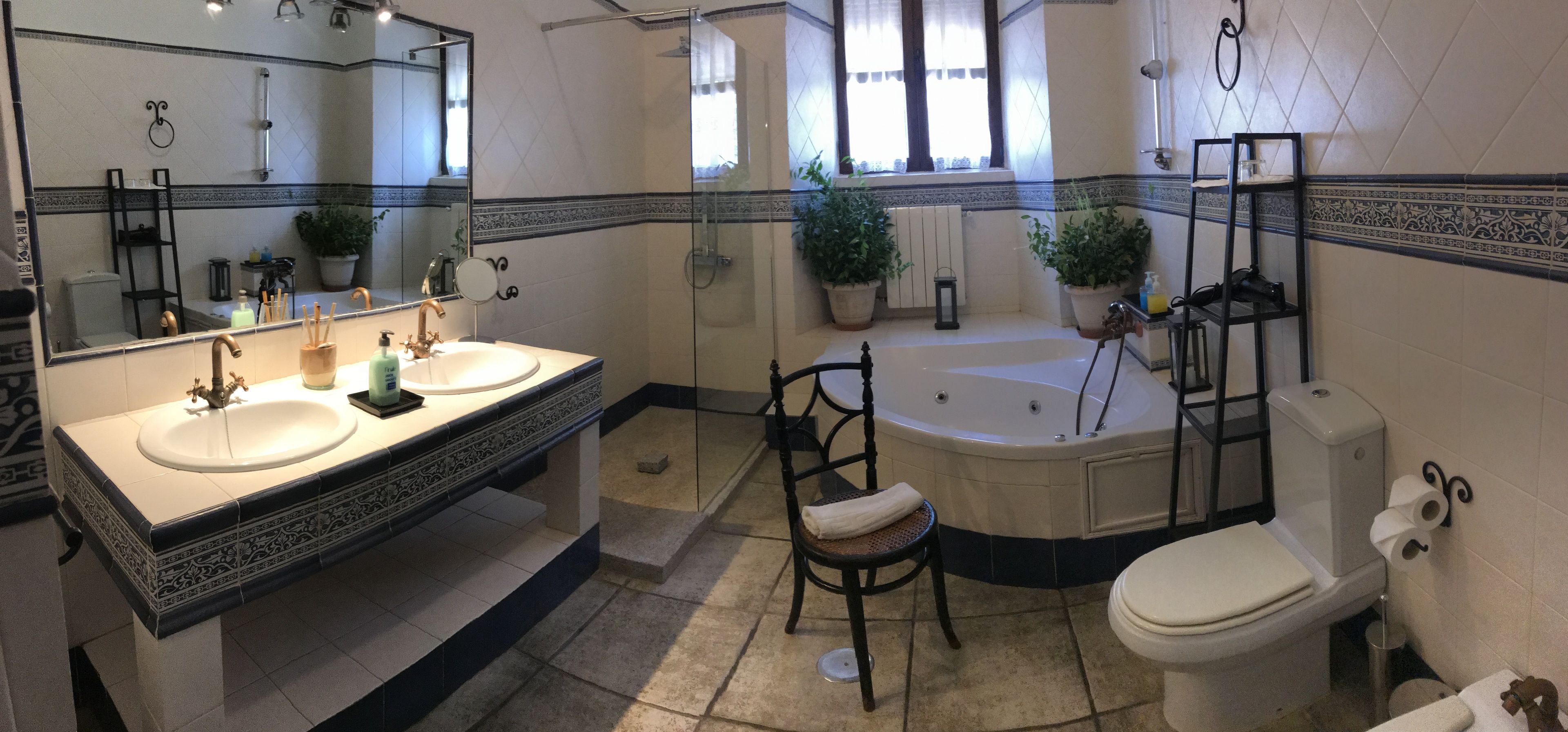 Een badkamer met twee wastafels, een bad en een toilet.
