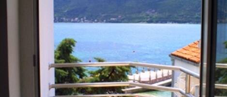 A balcony with a view of a lake and mountains.