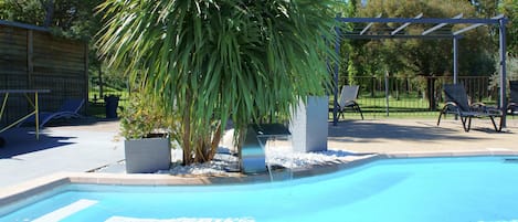 Seasonal outdoor pool, open 10:00 AM to 8:00 PM, pool loungers