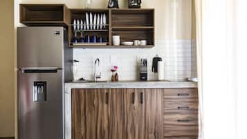 Full-sized fridge, coffee/tea maker, cookware/dishes/utensils