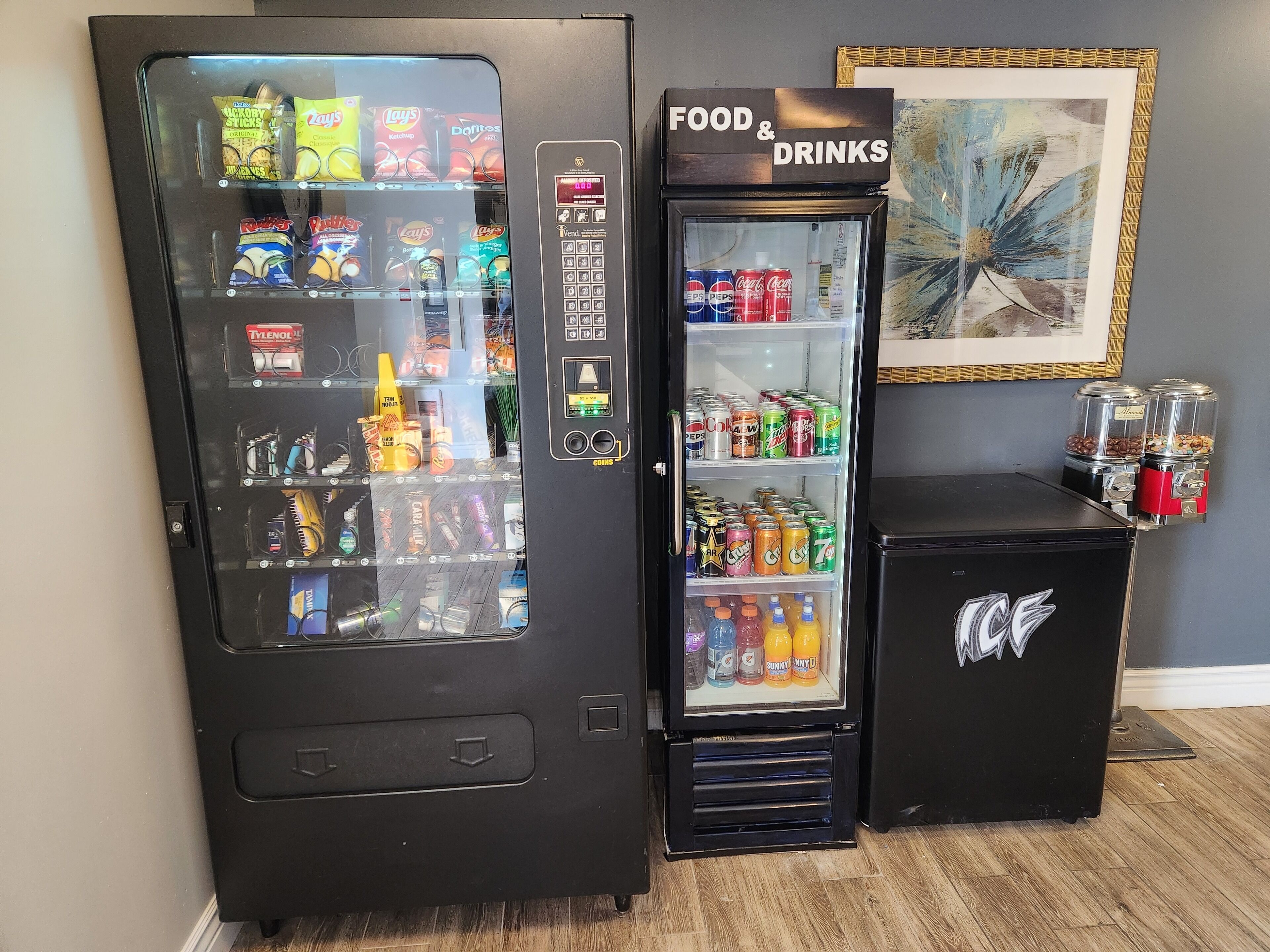 A vending machine with snacks and drinks, and a separate machine labeled "FOOD & DRINKS".