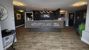 A reception area with a sign reading "NEWFOUND INN & SUITES". - Newfound Inn & Suites (Conception Bay South)