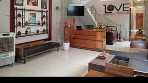 A modern living room with a sofa, coffee table, and decorative wall art. - Song Toan Hotel (Phong Nha)