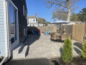 Enjoy a serene outdoor space with a patio, garden, and comfortable seating area.