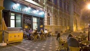 A café with outdoor seating, a chalkboard menu, and a dessert display. - Hotel Magnolia Roudnice (Roundnice nad Labem)
