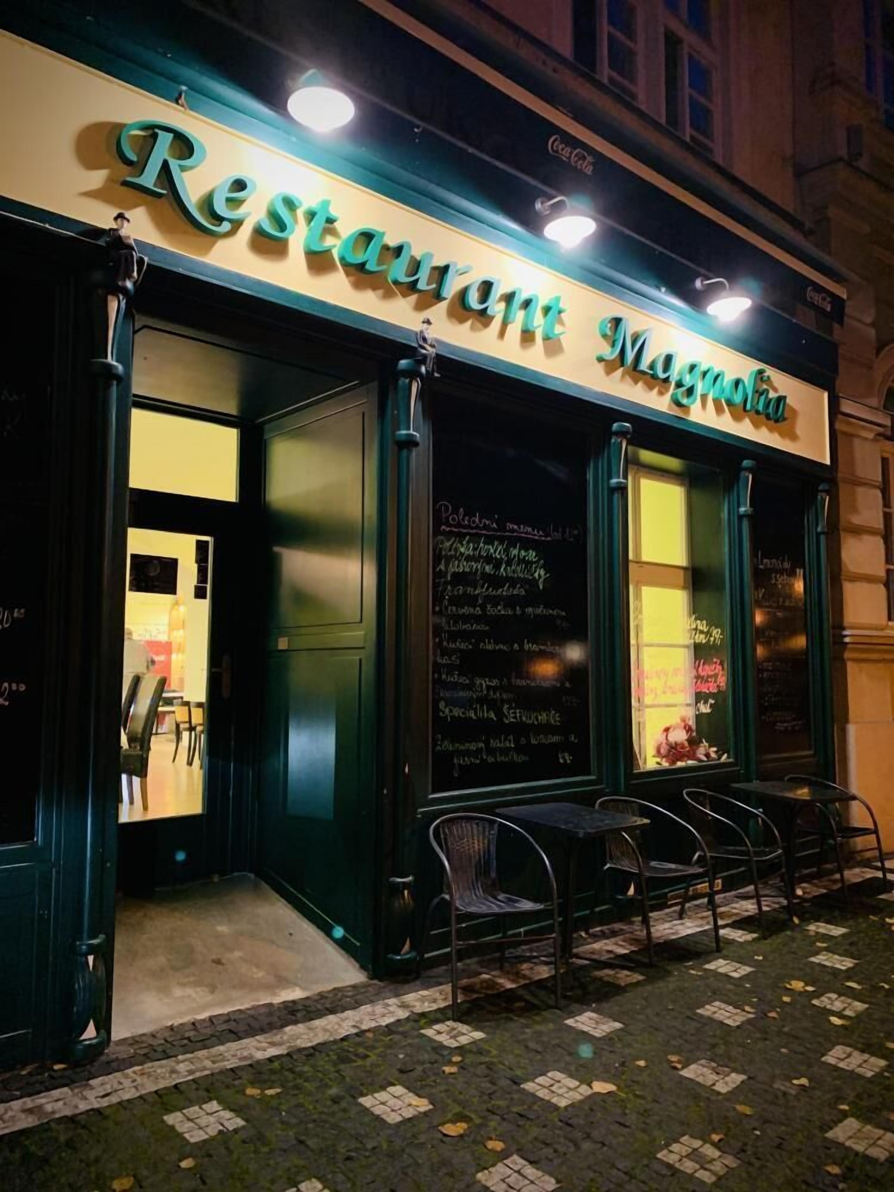A restaurant named 'Restaurant Magnolia' with outdoor seating and a chalkboard menu.