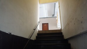 A staircase leading to a door marked 217. - Queens Hotel (Chum Phae)