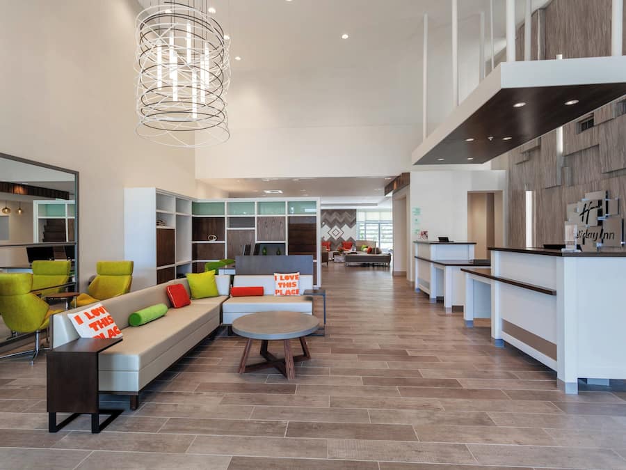 Een modern interieur met een zithoek, een keuken en een receptiebalie.