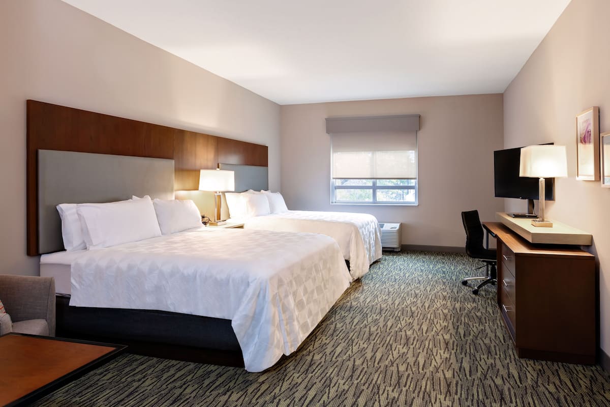 Hypo-allergenic bedding, desk, laptop workspace, blackout drapes