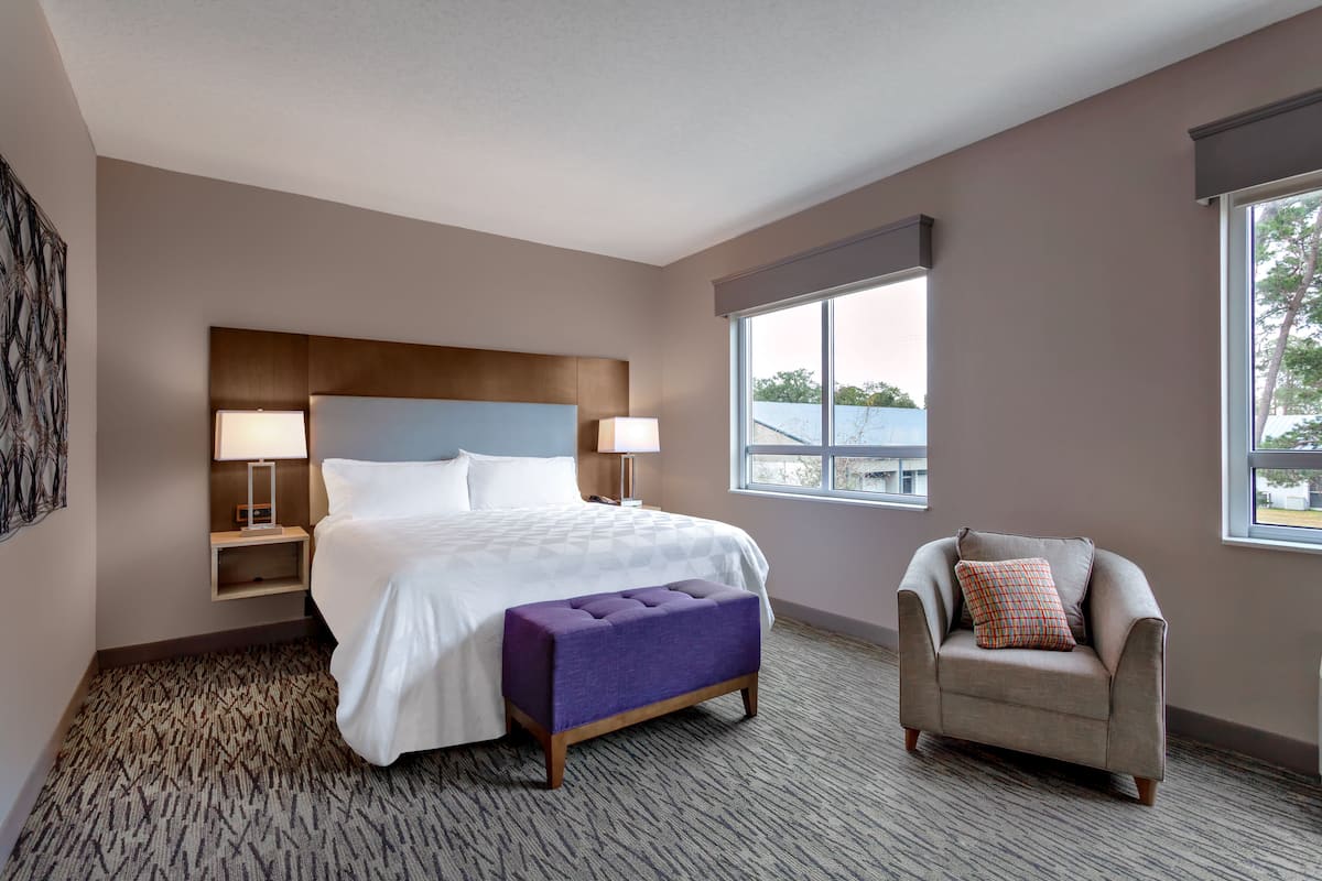 Hypo-allergenic bedding, desk, laptop workspace, blackout drapes