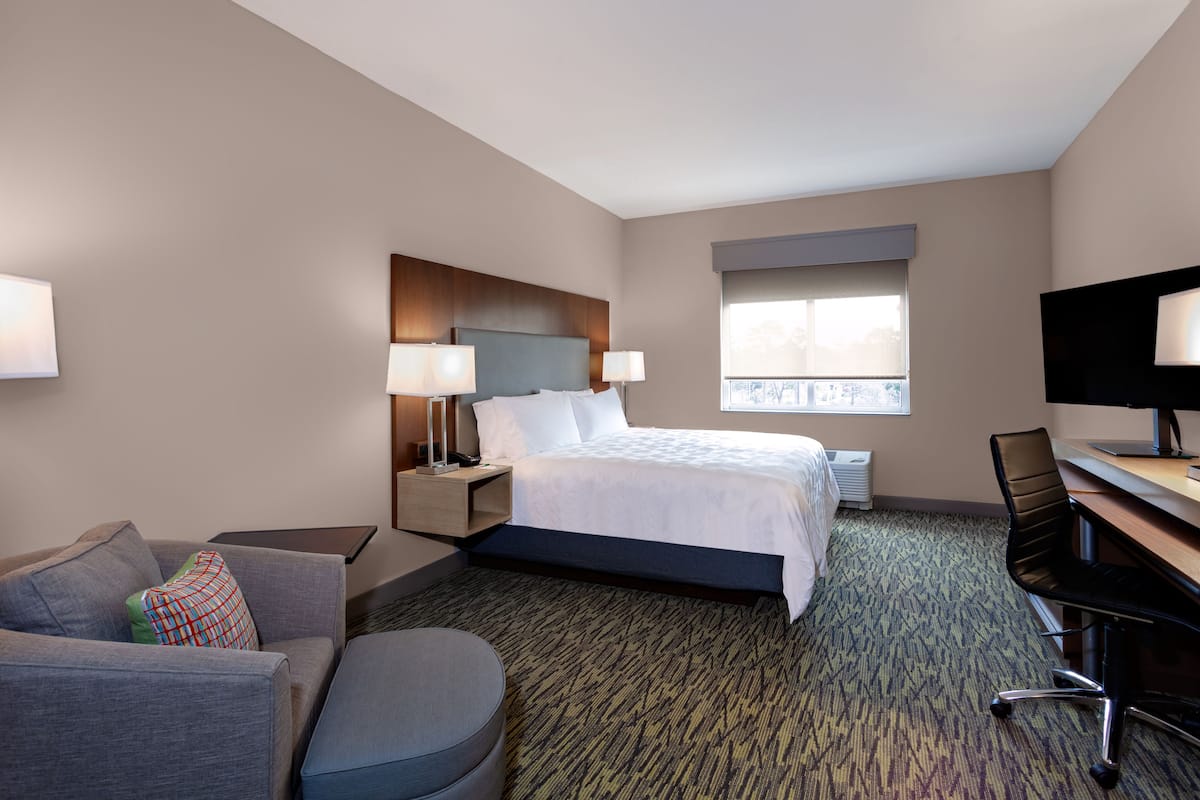 hypo-allergenic bedding, desk, laptop workspace, blackout curtains