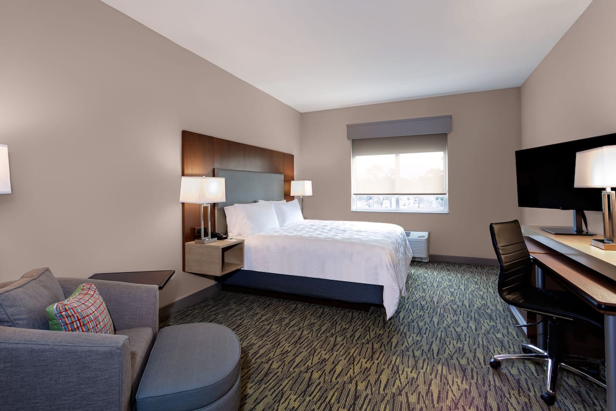 Hypo-allergenic bedding, desk, laptop workspace, blackout drapes
