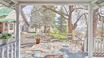 Relax in a sheltered outdoor space with a deck, seating areas, and a scenic view.