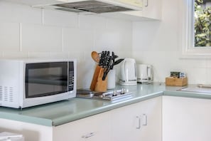 Fridge, microwave, stovetop, cookware/dishes/utensils