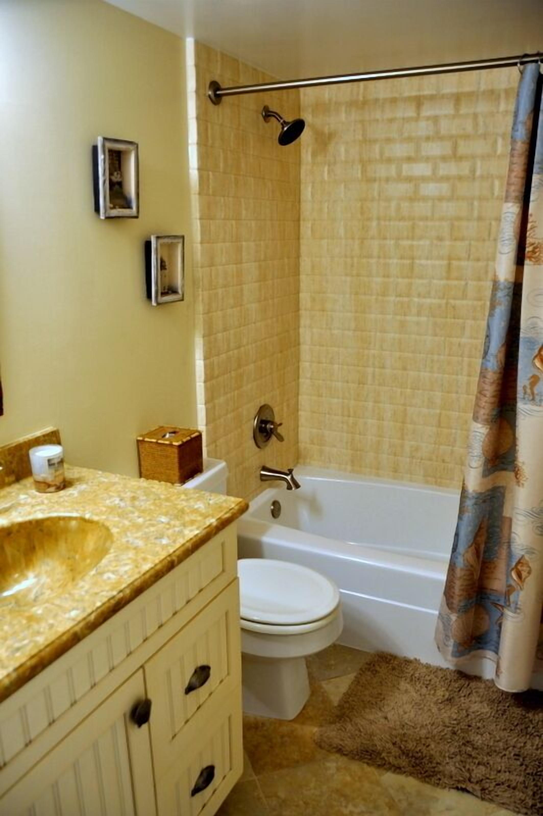 A bathroom with a bathtub, toilet, and sink.