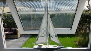 A sailboat model in a window.