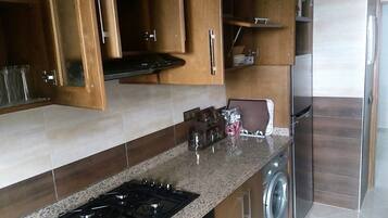 Family Apartment, 3 Bedrooms | Private kitchen | Fridge, microwave, stovetop, coffee/tea maker