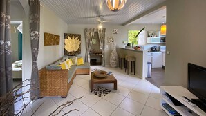 Un salon moderne avec un canapé, une table basse et un téléviseur.