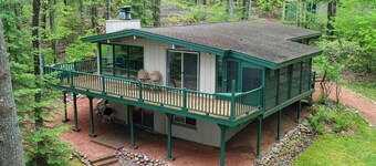 Large lakeside 'treehouse' with enclosed porch, dock, pool table, and fire pit!