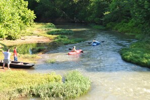 A river with kayaks and people on the bank. - Chickamauga Lee & Gordon's Mills Historic Pierce House (Chickamauga)