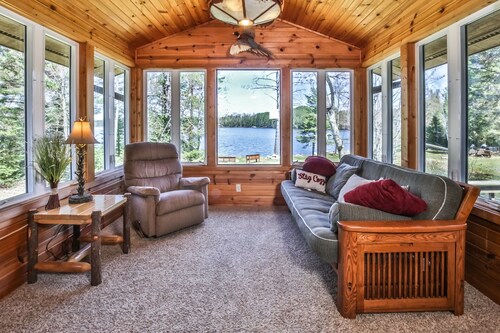 Level lakefront property with spacious cabin, private dock, and fire pit!