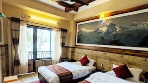 A hotel room with two beds, a large painting of mountains, a wooden ceiling, and a window with curtains. - Hotel Forest Lake Backpackers' Hostel (Pokhara)