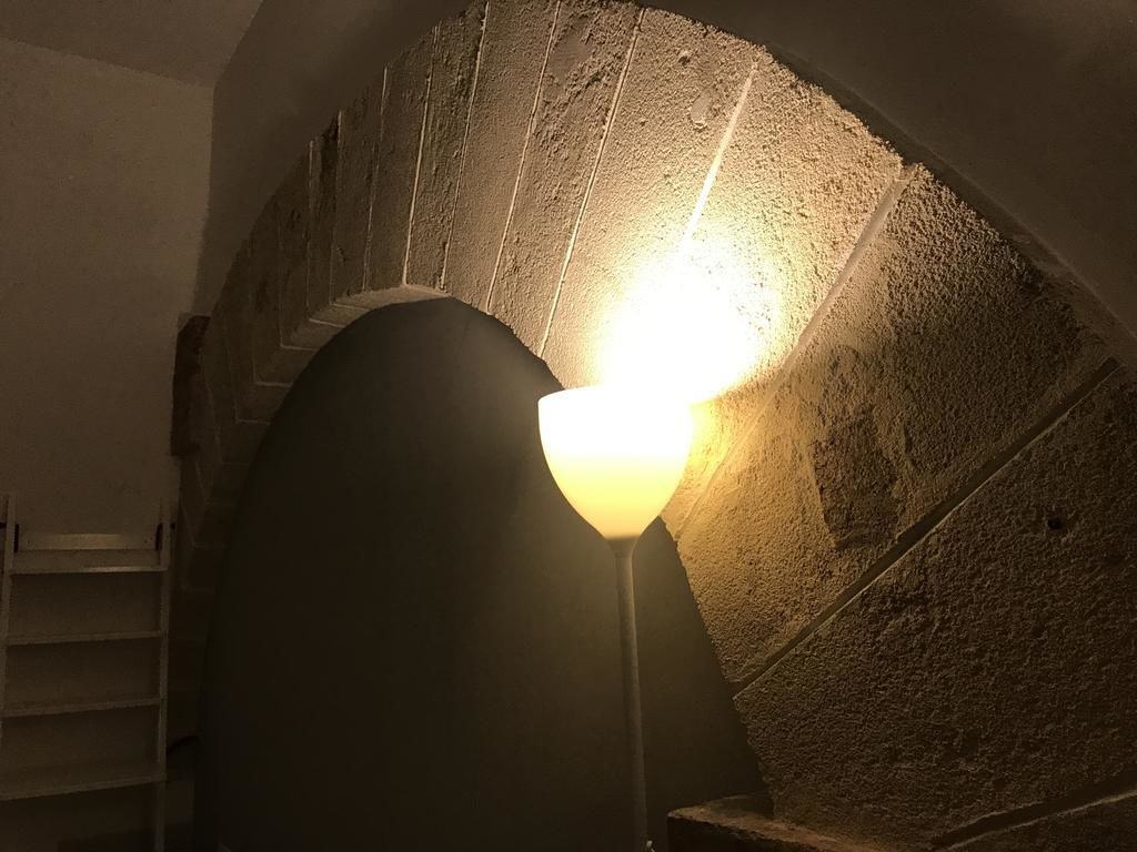 A stone archway with a light fixture in the center.