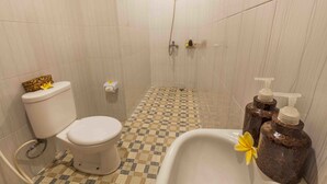 A bathroom with a toilet, shower, and sink. - Vimala Ubud Hotel (Ubud)