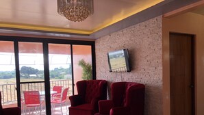 Apartemen Deluks, 1 kamar tidur | Ruang keluarga | Televisi layar datar 55-inci dengan saluran TV digital dan Smart TV