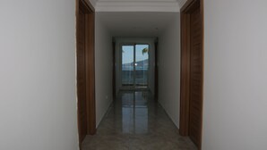 A hallway with a view of a body of water and a mountain in the distance. - Geo Beach Hotel Marmaris (Marmaris)