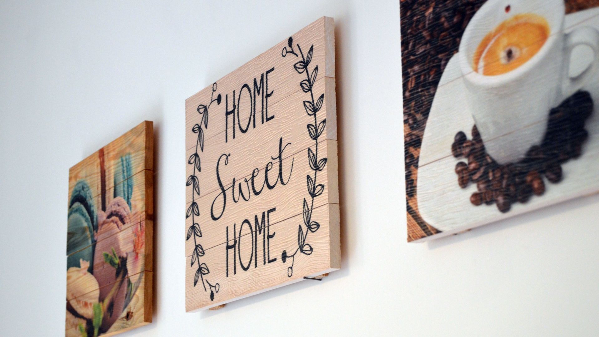Three wooden signs with text and decorative elements.