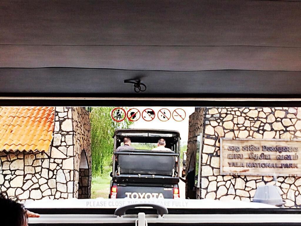 A vehicle with a sign reading "Yala National Park" and a warning sign with various prohibitions.
