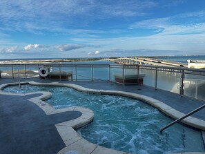 A hot tub area with a view of the ocean and a bridge. - REMODELED High Floor-Large 3 bedroom/3 full bath corner unit (Destin)