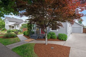 A residential house with a front yard, a driveway, and a garage.