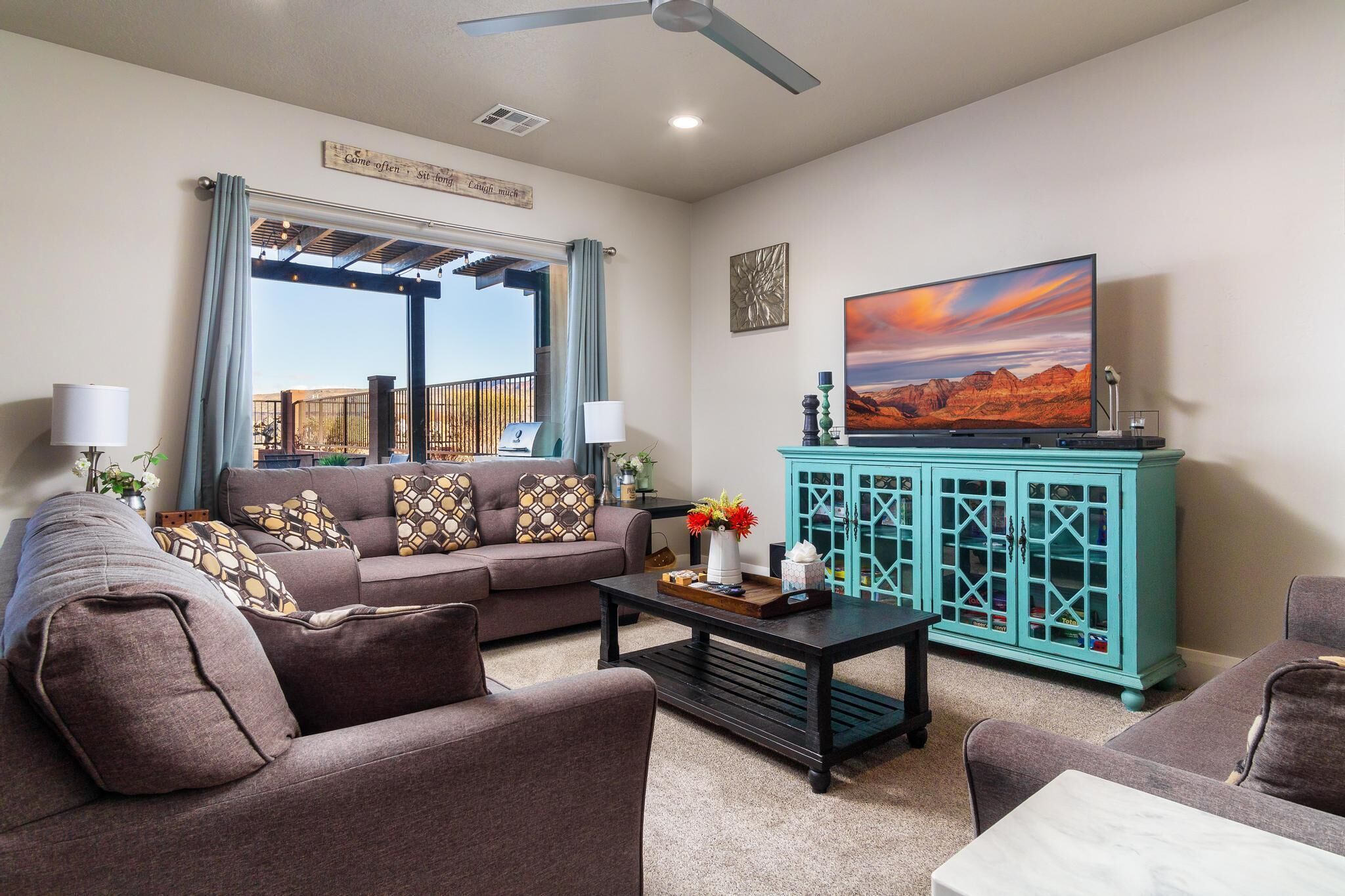 A living room with a sofa, coffee table, and a TV on a stand.