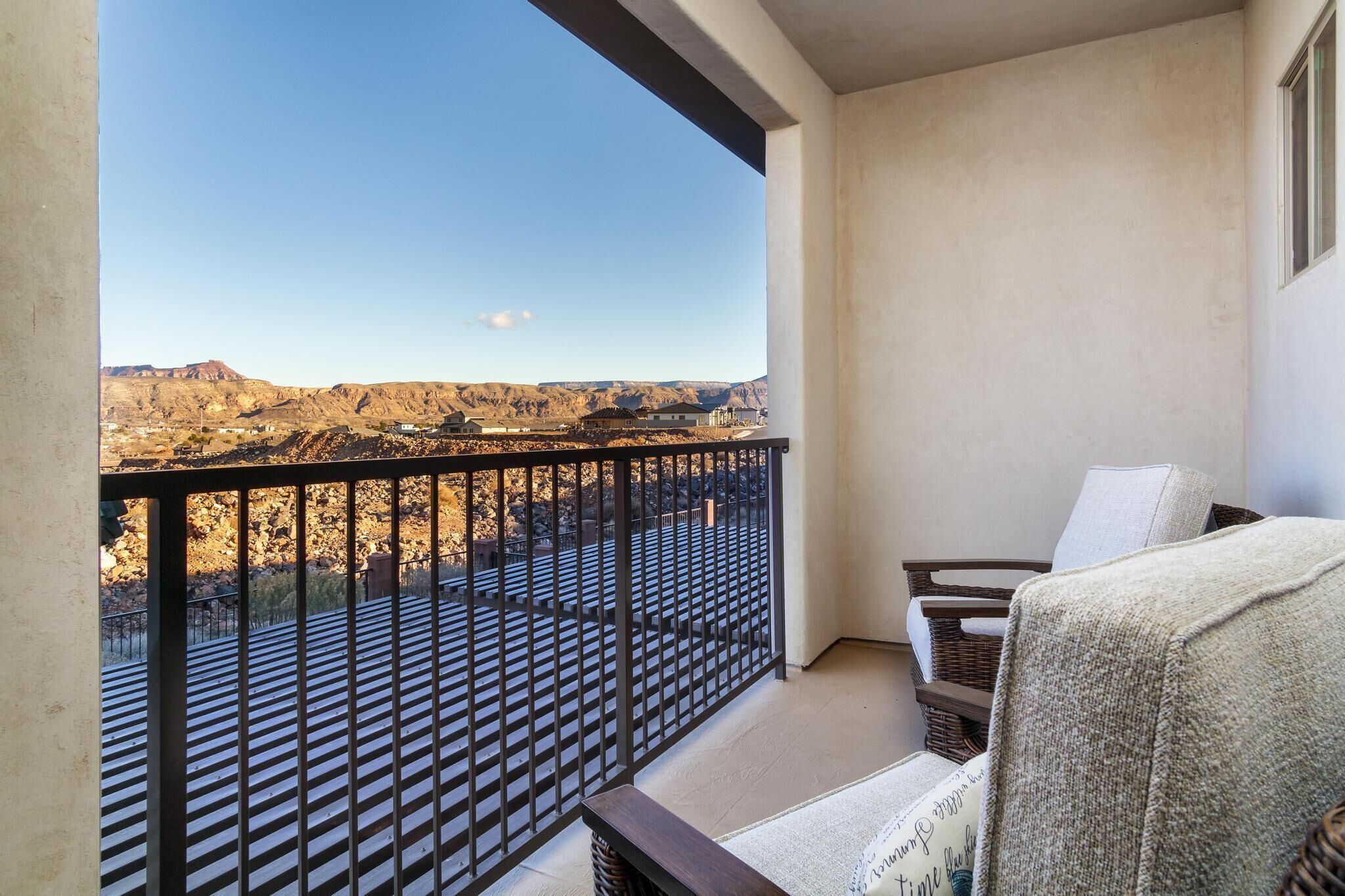 A balcony with a view of a mountainous landscape.