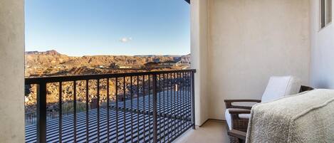 A balcony with a view of a mountainous landscape.