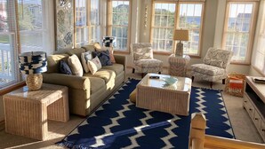 A living room with a sofa, armchairs, a coffee table, and a patterned rug. - Two Crabby: Feels like home! Spectacular views, Beach Club Summer 2026! (Nags Head)