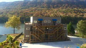 A multi-story building with a blue awning, wooden railings, and a staircase leading to the upper floors. - Waterfront Paradise- 10 minutes from downtown Chattanooga (Chattanooga)