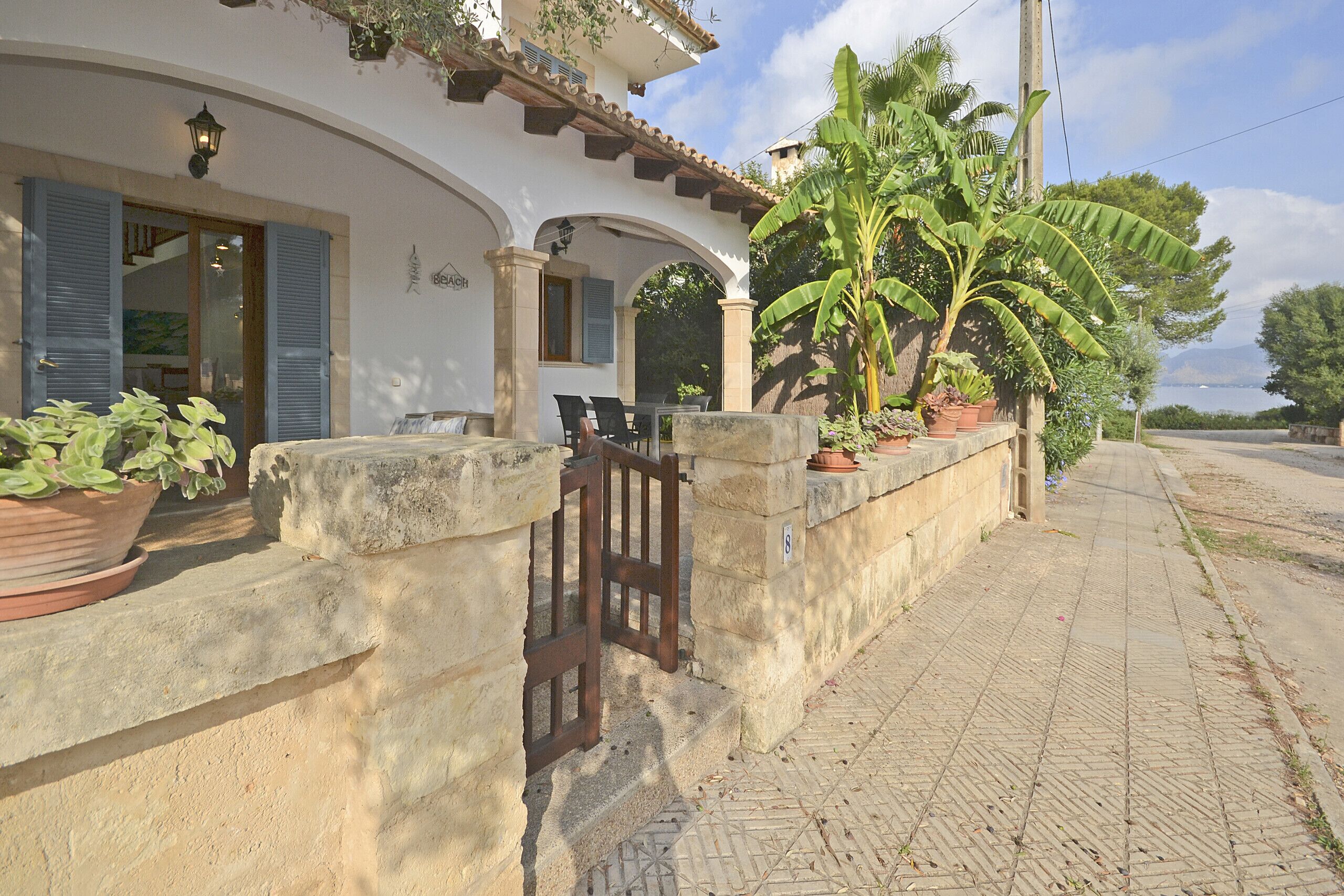 A building with a stone facade, arched windows, and a gated entrance.