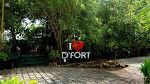 A paved pathway leading to a sign with 'I ♥ D'FORT' and a heart symbol. - Dfort Hotel Kollam (Kollam)