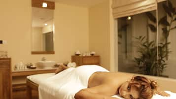 Experience relaxation in this serene spa setting, featuring a massage table, self-service vanity with sink, and a calming atmosphere.