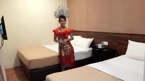A hotel room with two beds, a wooden headboard, a chandelier, and a TV on the wall. - Tey Hotel (Pasir Gudang)