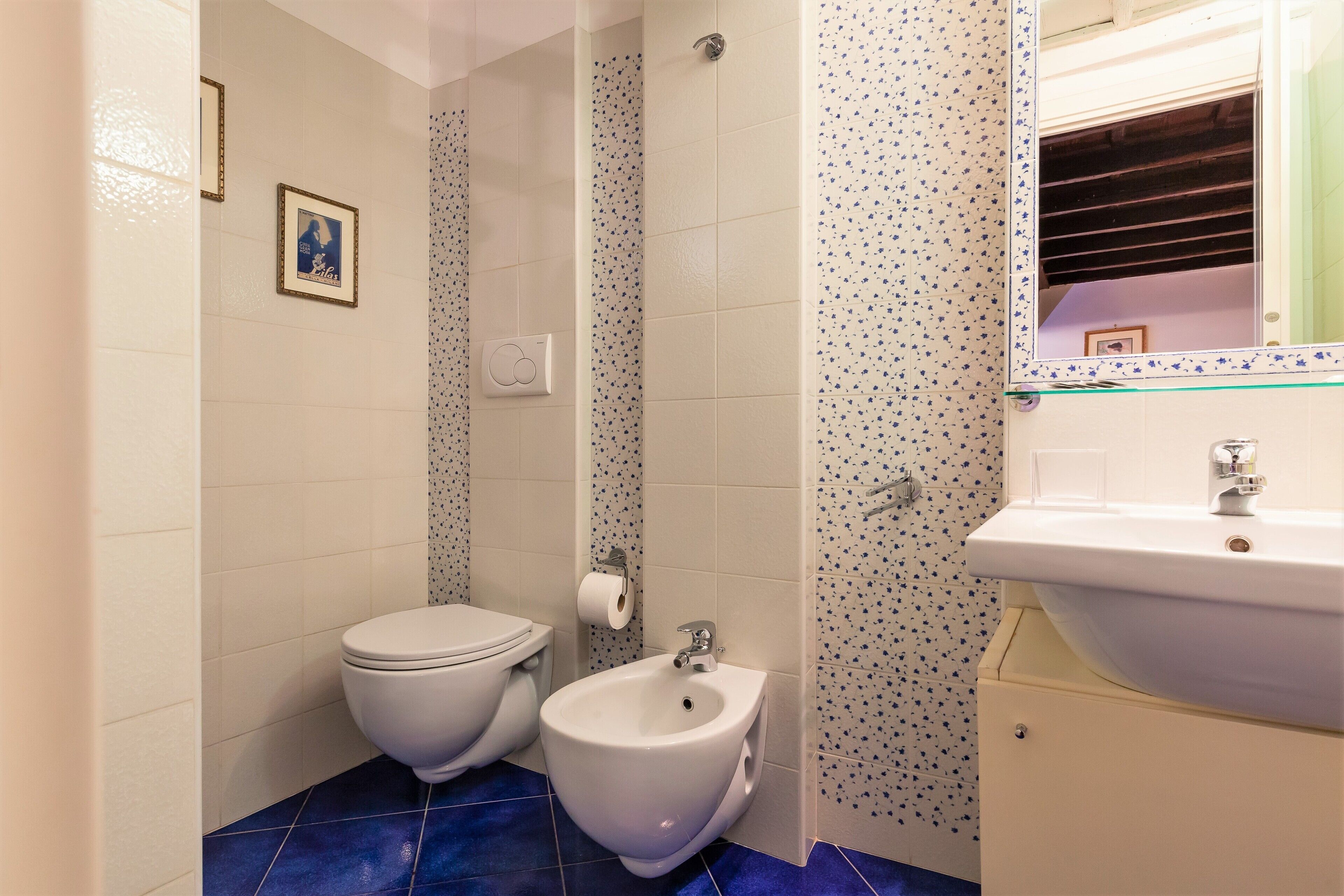 A bathroom with a toilet, bidet, and sink.