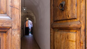 A wooden hallway with a door and a hanging light fixture. -  Rome center Campo de Fiori great reviews within walking distance to everything! (Roma)
